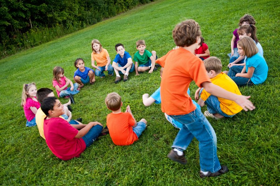 Circle of children playing duck duck goose