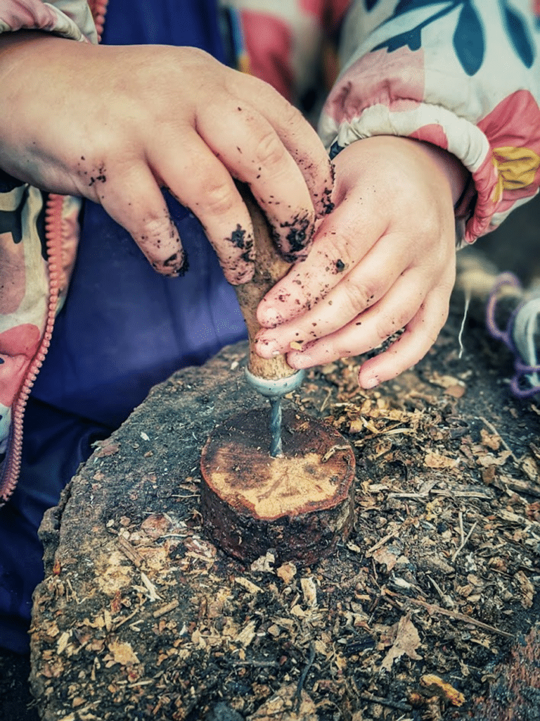 A small handheld drill held by a child