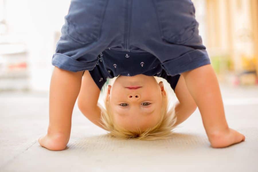 Toddler watching TV upside down
